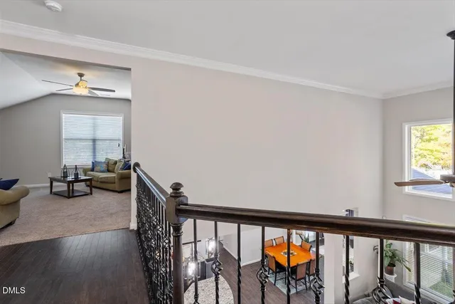 a living room with furniture and a ceiling fan