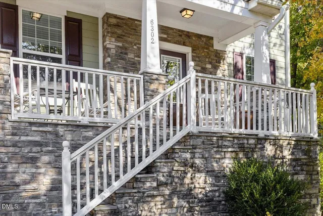 a view of a balcony with wooden floor and fence
