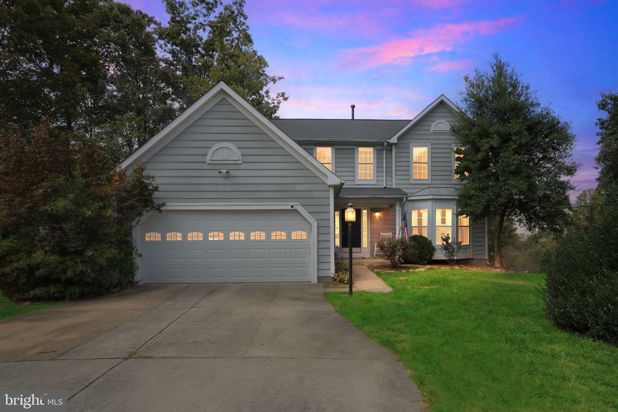 a view of a house with a yard and tree s