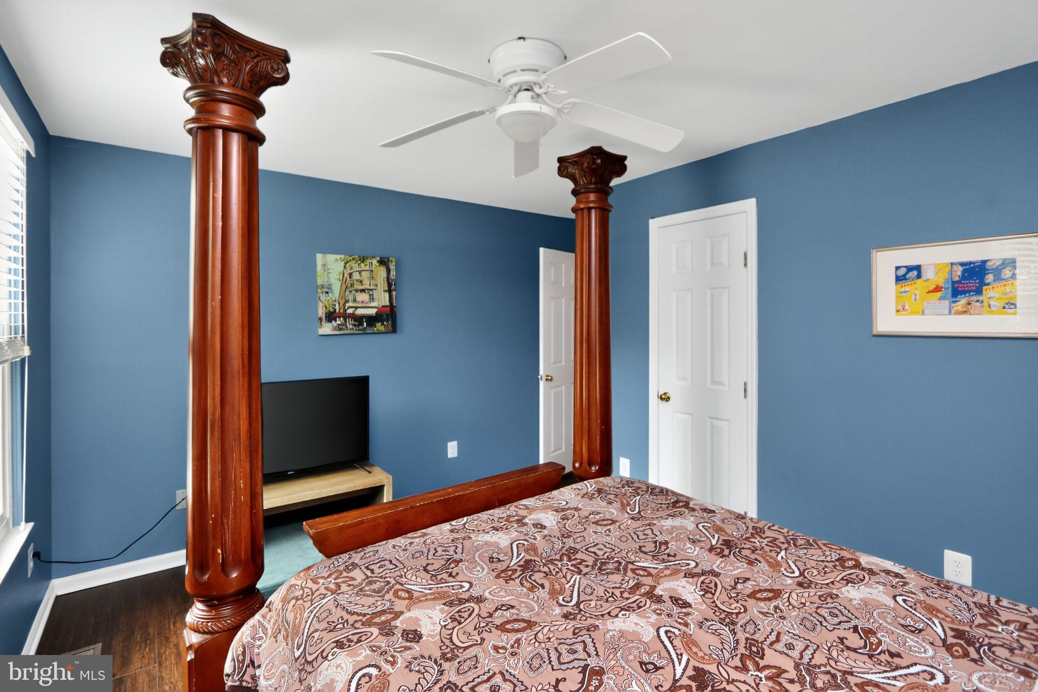 16601 Accolon Court Dumfries, VA 22025 - Photo 25 of 34 a bedroom with a bed and a chandelier