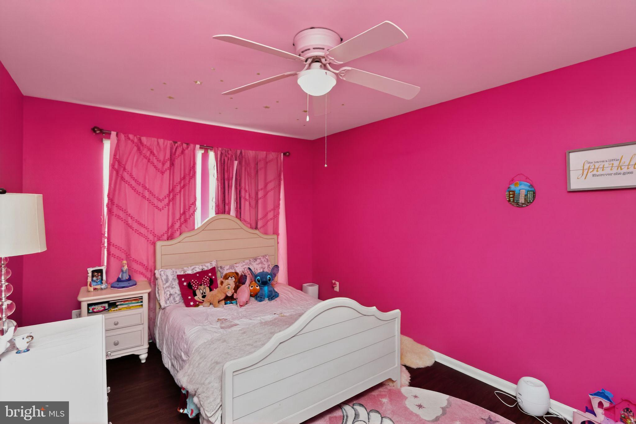 16601 Accolon Court Dumfries, VA 22025 - Photo 27 of 34 a bedroom with a bed and a chandelier