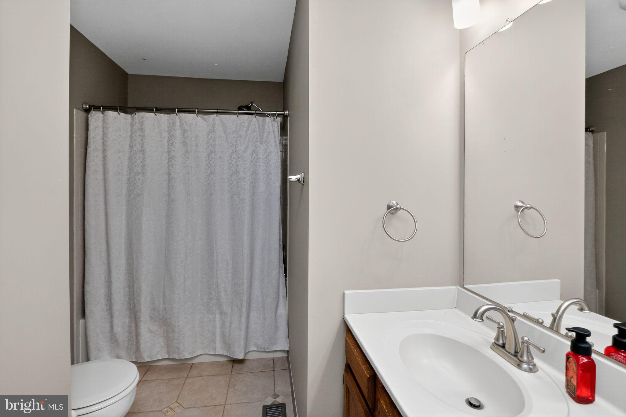 16601 Accolon Court Dumfries, VA 22025 - Photo 29 of 34 a bathroom with a sink toilet and shower