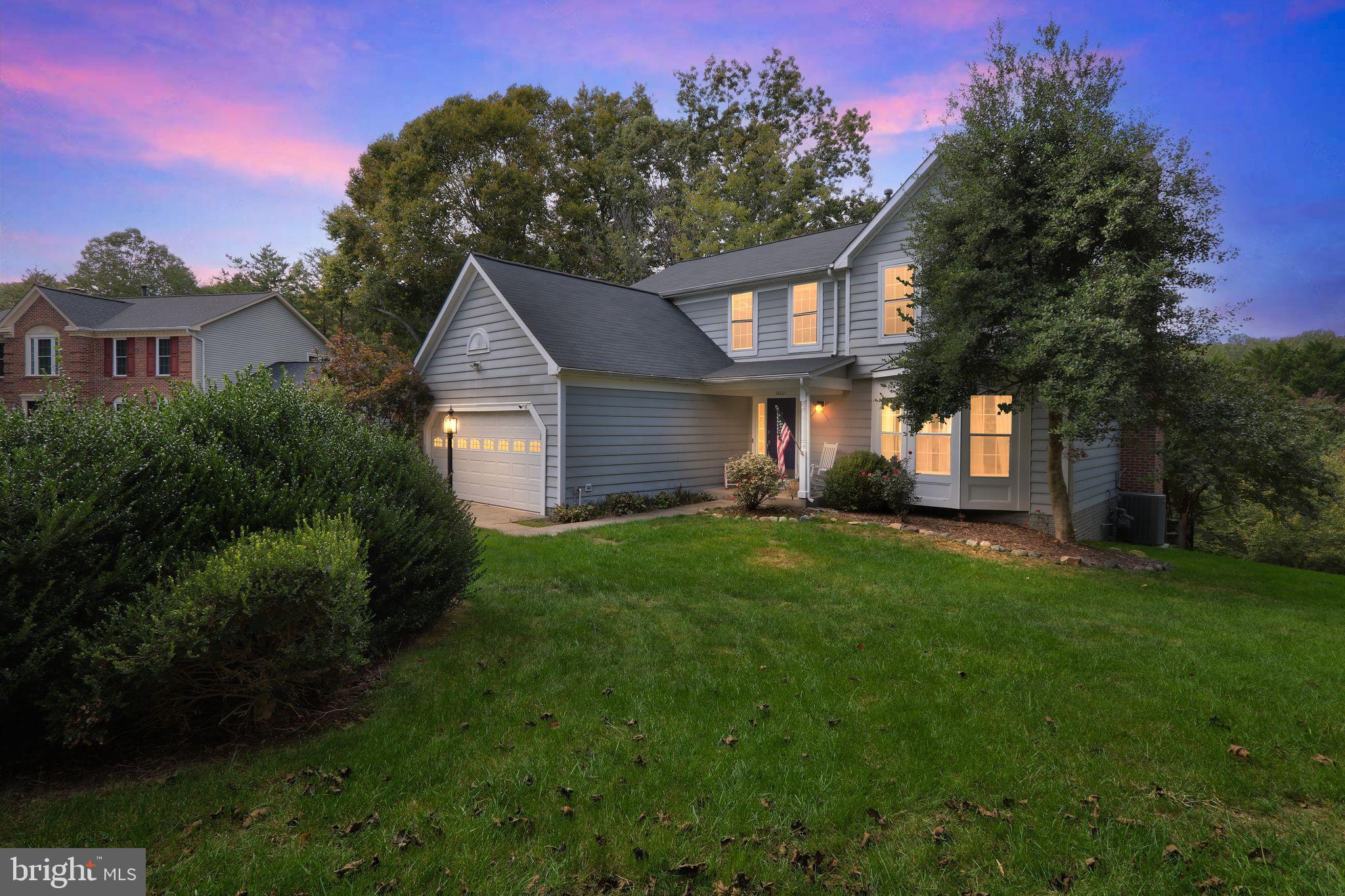16601 Accolon Court Dumfries, VA 22025 - Photo 3 of 34 a front view of a house with a yard and trees