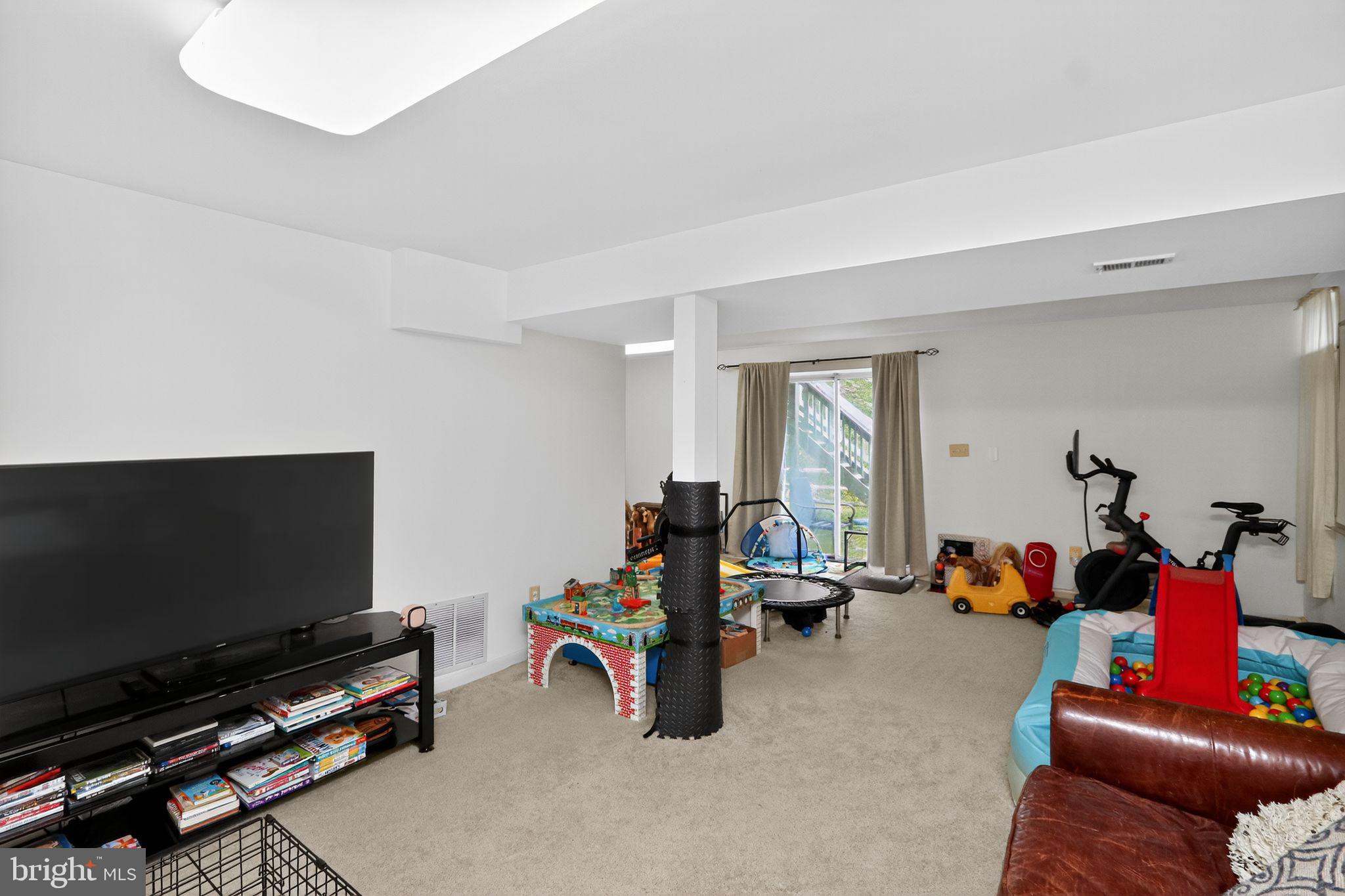 16601 Accolon Court Dumfries, VA 22025 - Photo 31 of 34 a living room with furniture and a flat screen tv