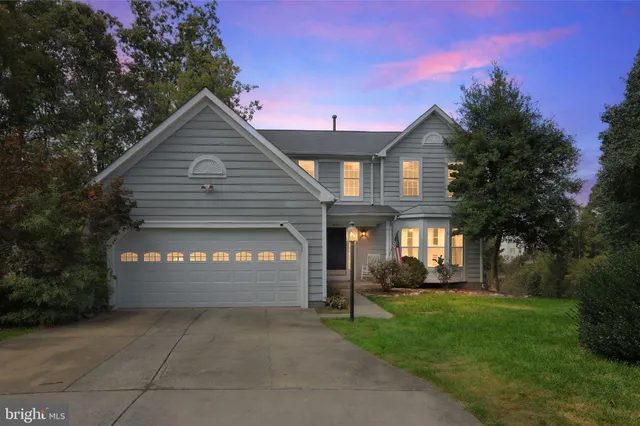 a front view of a house with a yard and outdoor seating