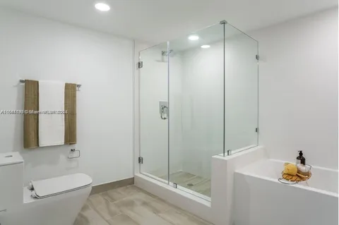 a bathroom with a shower a toilet and sink