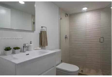 a bathroom with a sink toilet and shower