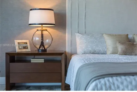 a bedroom with a bed and a mirror