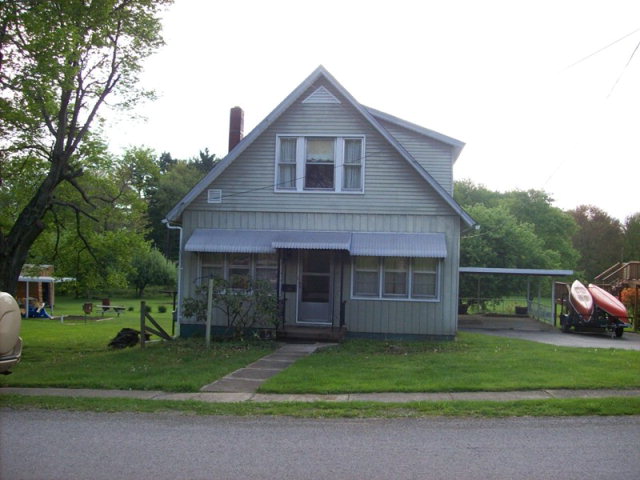 178 Community Road Emlenton, PA 16373 - Photo 1 of 1 a front view of a house with a garden and trees
