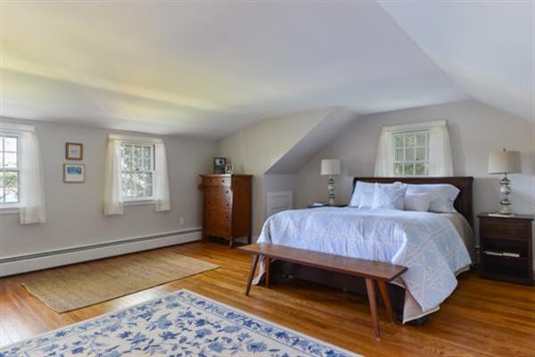 124 Namequoit Road Orleans, MA 02653 - Photo 18 of 30 a bedroom with a bed rug and wooden floor