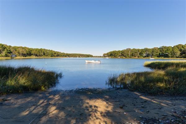 124 Namequoit Road Orleans, MA 02653 - Photo 28 of 30 a view of a lake with houses in the back