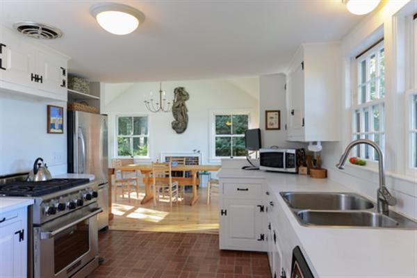 124 Namequoit Road Orleans, MA 02653 - Photo 10 of 30 a kitchen with stainless steel appliances granite countertop a sink stove and cabinets