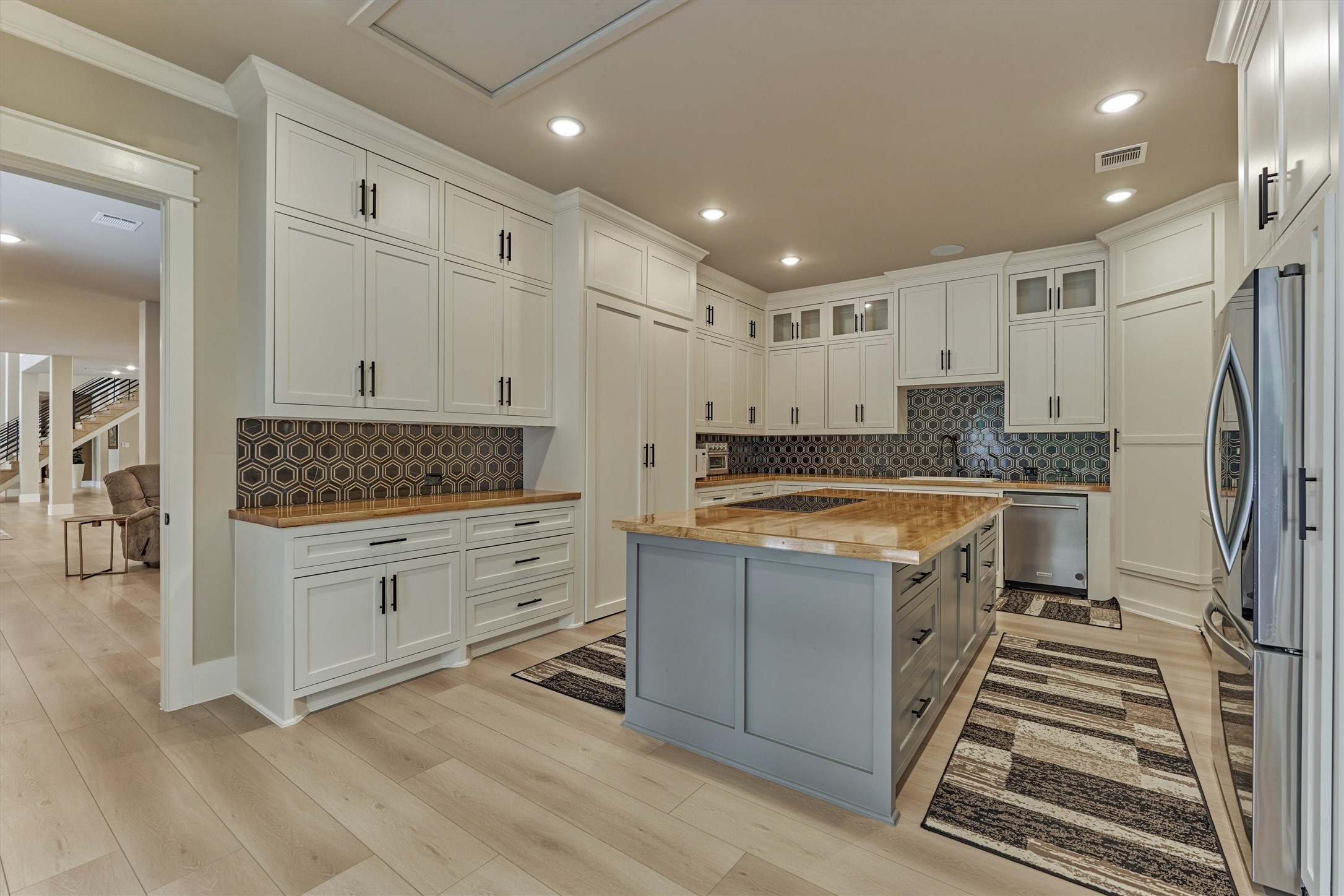 1907 Woerner Road Houston, TX 77090 - Photo 15 of 50 The back kitchen is located right off of the grand family room. This kitchen features butcher block countertops, induction range, refrigerator plus a full size freezer.
