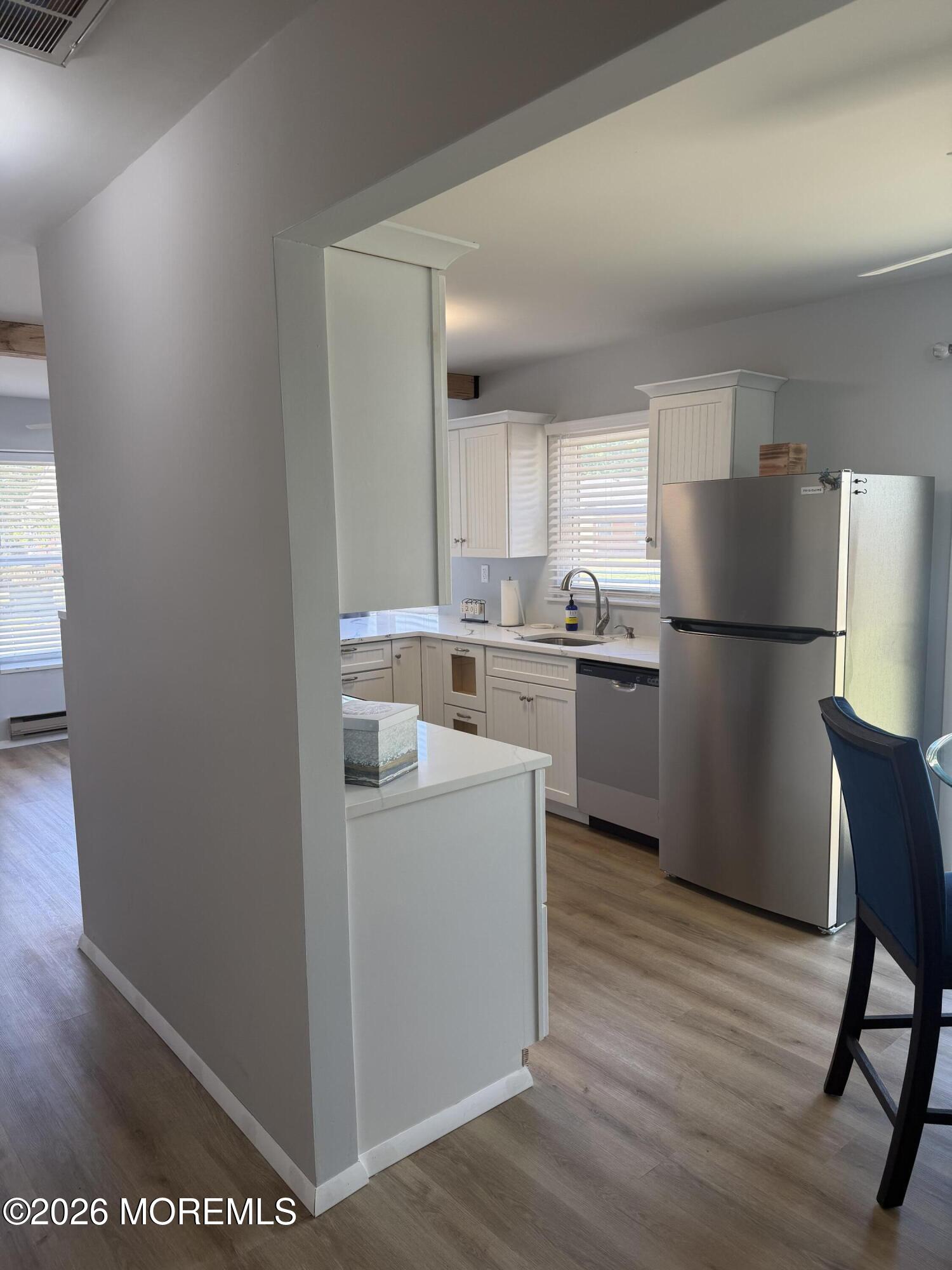 31 Homestead Drive, Unit A Whiting, NJ 08759 - Photo 18 of 23 a kitchen with a refrigerator sink and wooden floor