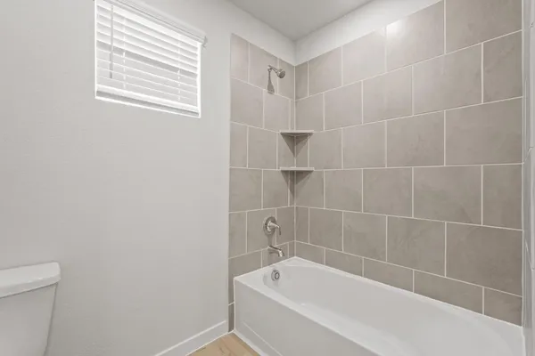 a white bath tub sitting next to a white toilet