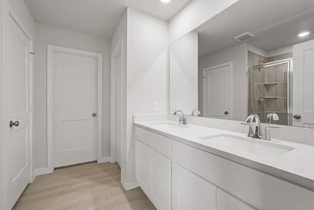 a bathroom with a double vanity sink and a mirror