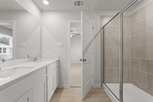a bathroom with a double vanity sink and mirror