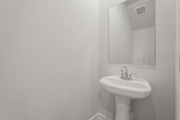 a bathroom with a sink and mirror