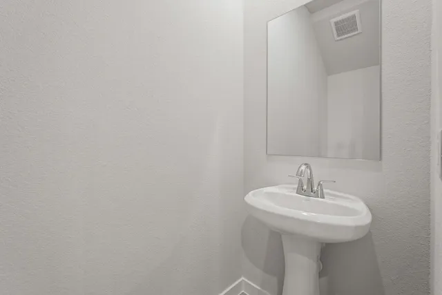 a bathroom with a sink and mirror