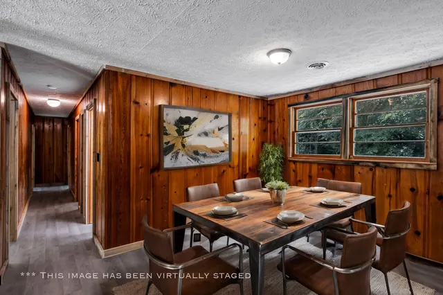 a view of a dining room with furniture window and outside view