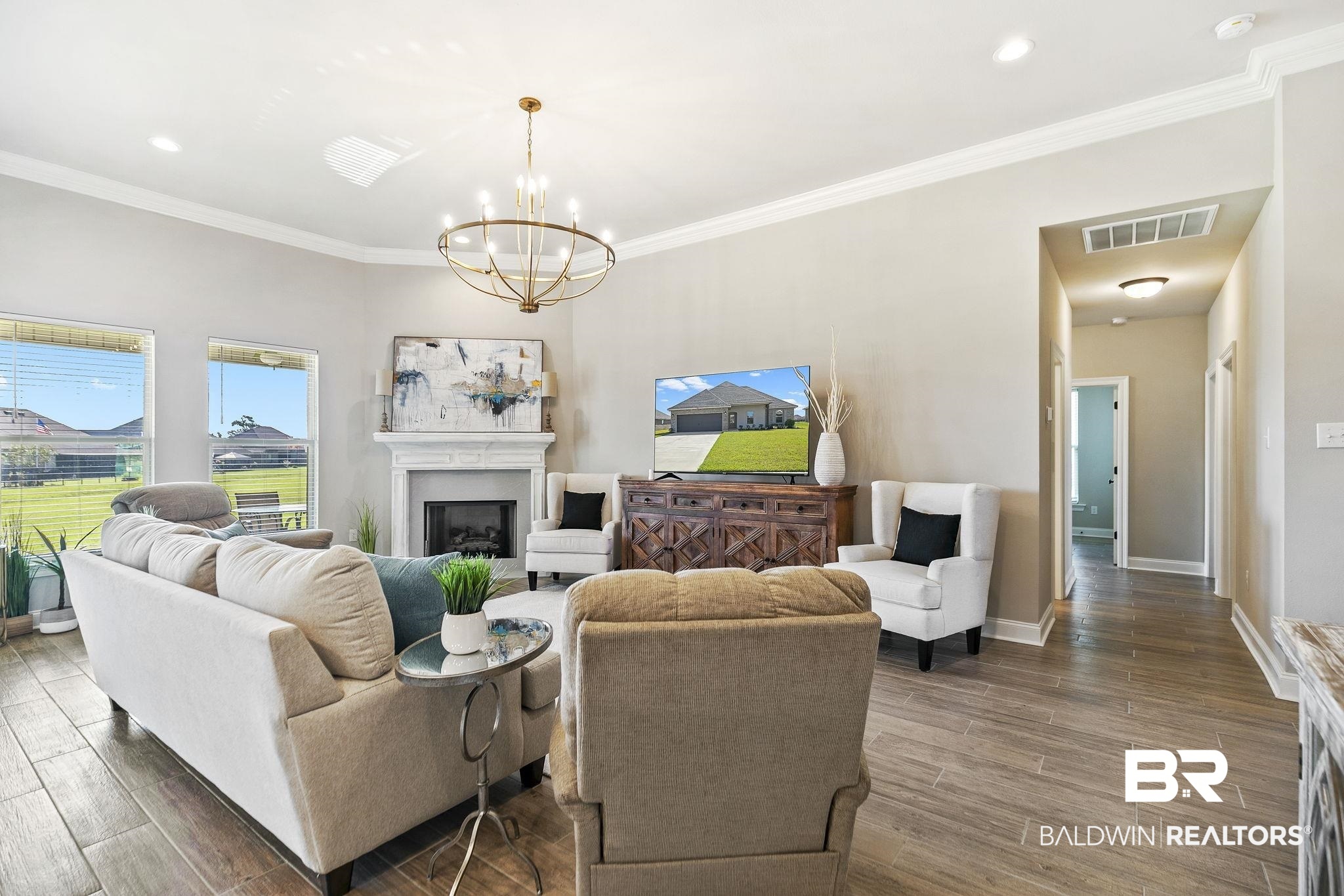 10140 Chipper Lane Foley, AL 36535 - Photo 12 of 72 Living room featuring dark hardwood / wood-style floors, ornamental molding, and a chandelier