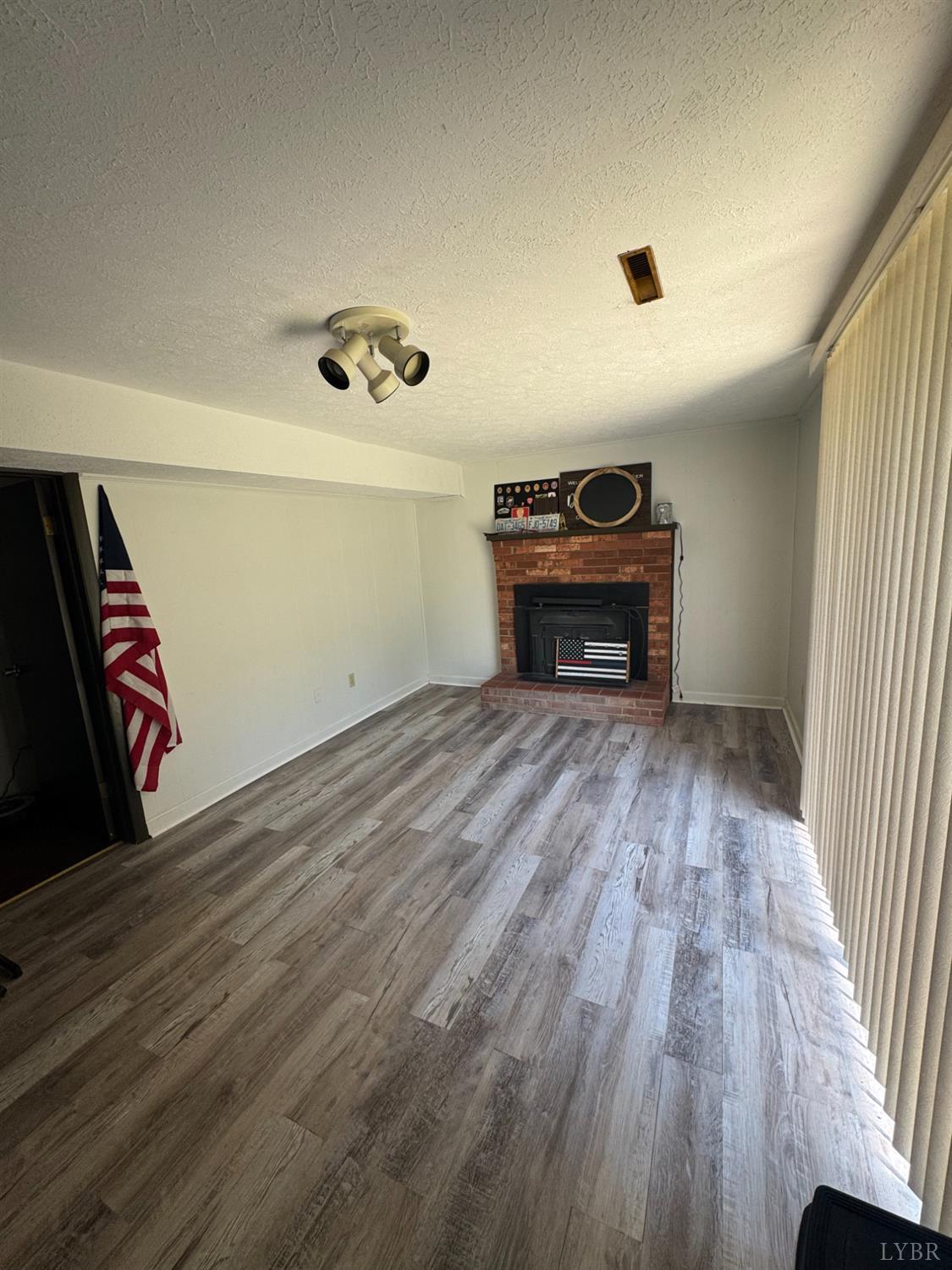 108 Hillside Road Hurt, VA 24563 - Photo 20 of 28 wooden floor in an empty room with a window