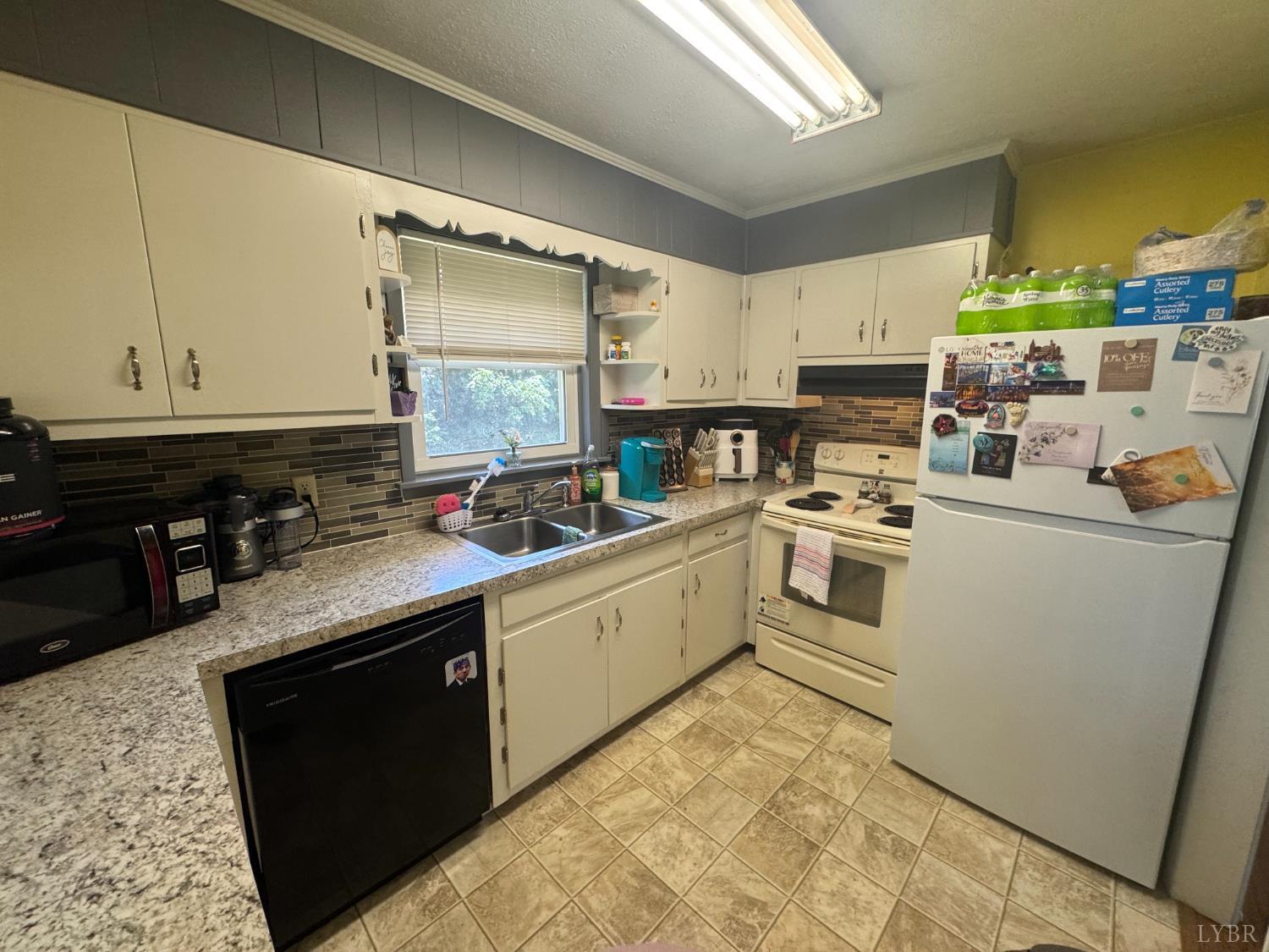 108 Hillside Road Hurt, VA 24563 - Photo 5 of 28 a kitchen with a sink dishwasher stove and white cabinets