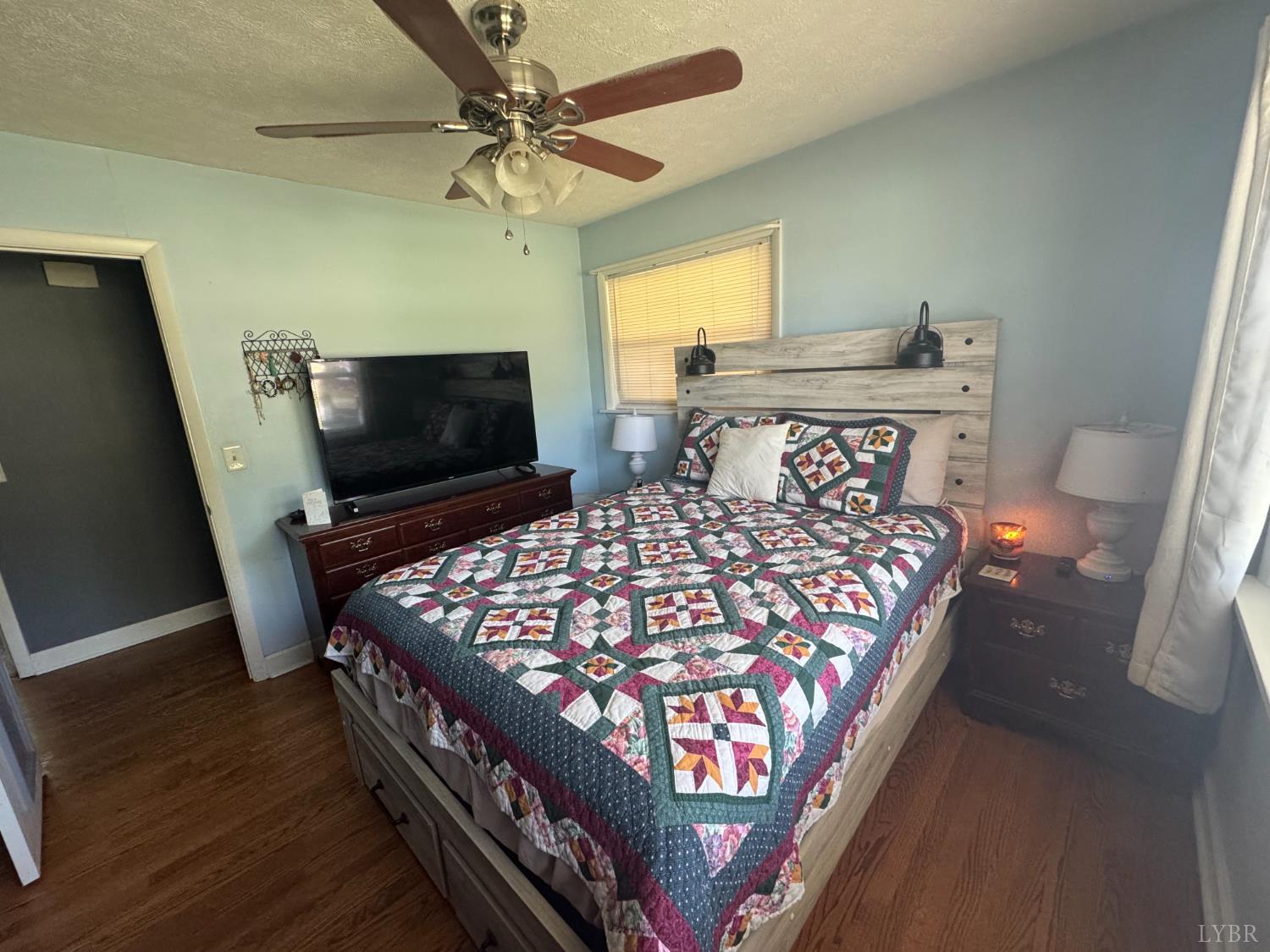 108 Hillside Road Hurt, VA 24563 - Photo 8 of 28 a bed sitting in a bedroom next to a window with a flat screen tv and dresser