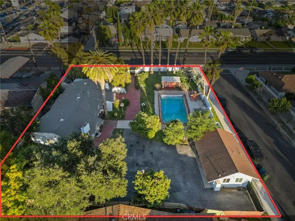 an aerial view of a house with a yard and a garden