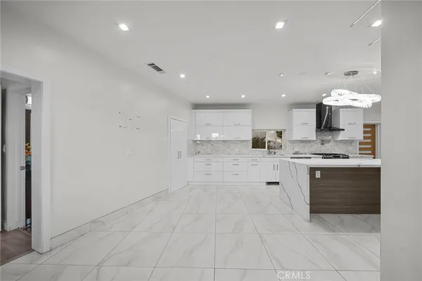 a view of empty room with wooden floor and fireplace