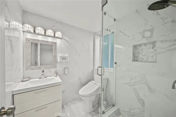 a bathroom with a sink a mirror and a toilet