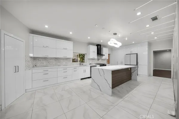 a kitchen with a stove a refrigerator and a sink