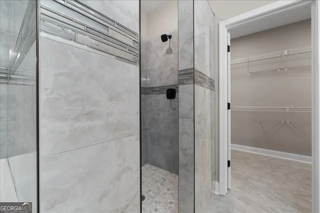 a bathroom with a glass shower door