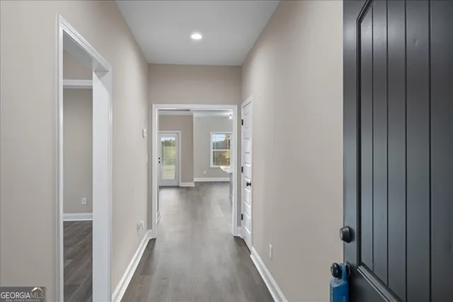 a view of a hallway with wooden floor
