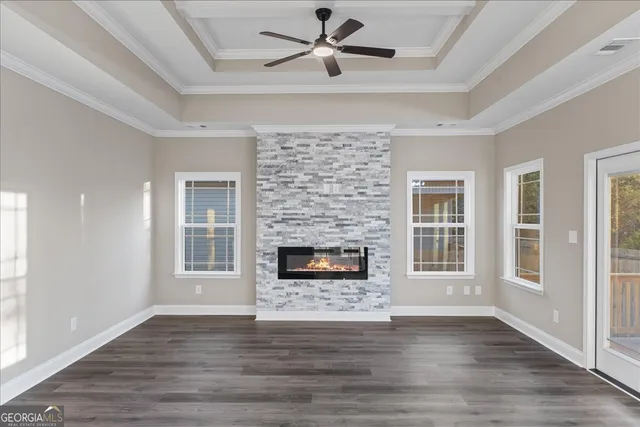 a living room with a fireplace and wooden floor