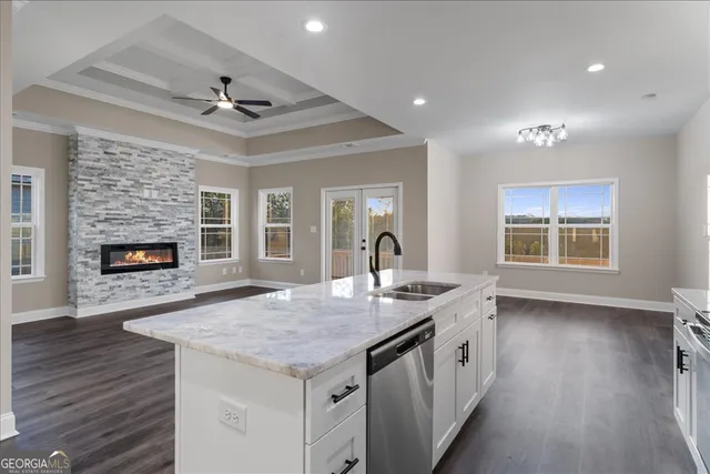 an open kitchen with a sink and a fireplace