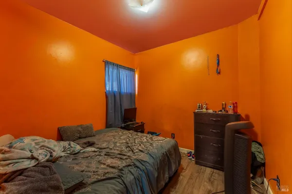 a bed sitting in a bedroom next to a window