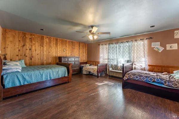 a bedroom with a bed couch and a window