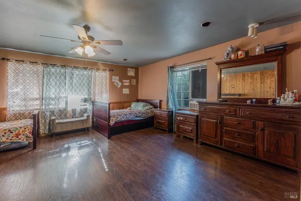 a bedroom with furniture and wooden floor
