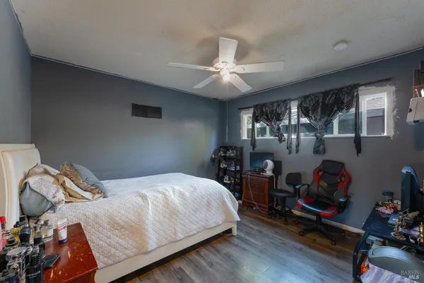 a bedroom with a bed closet and a window