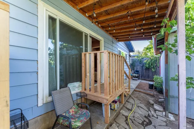 a view of patio with a table and chairs and potted plants