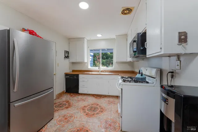 a kitchen with a refrigerator and a sink