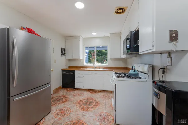 a kitchen with a refrigerator and a sink