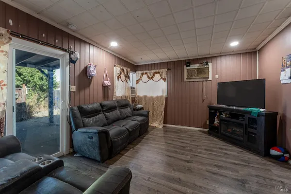 a living room with furniture and a flat screen tv