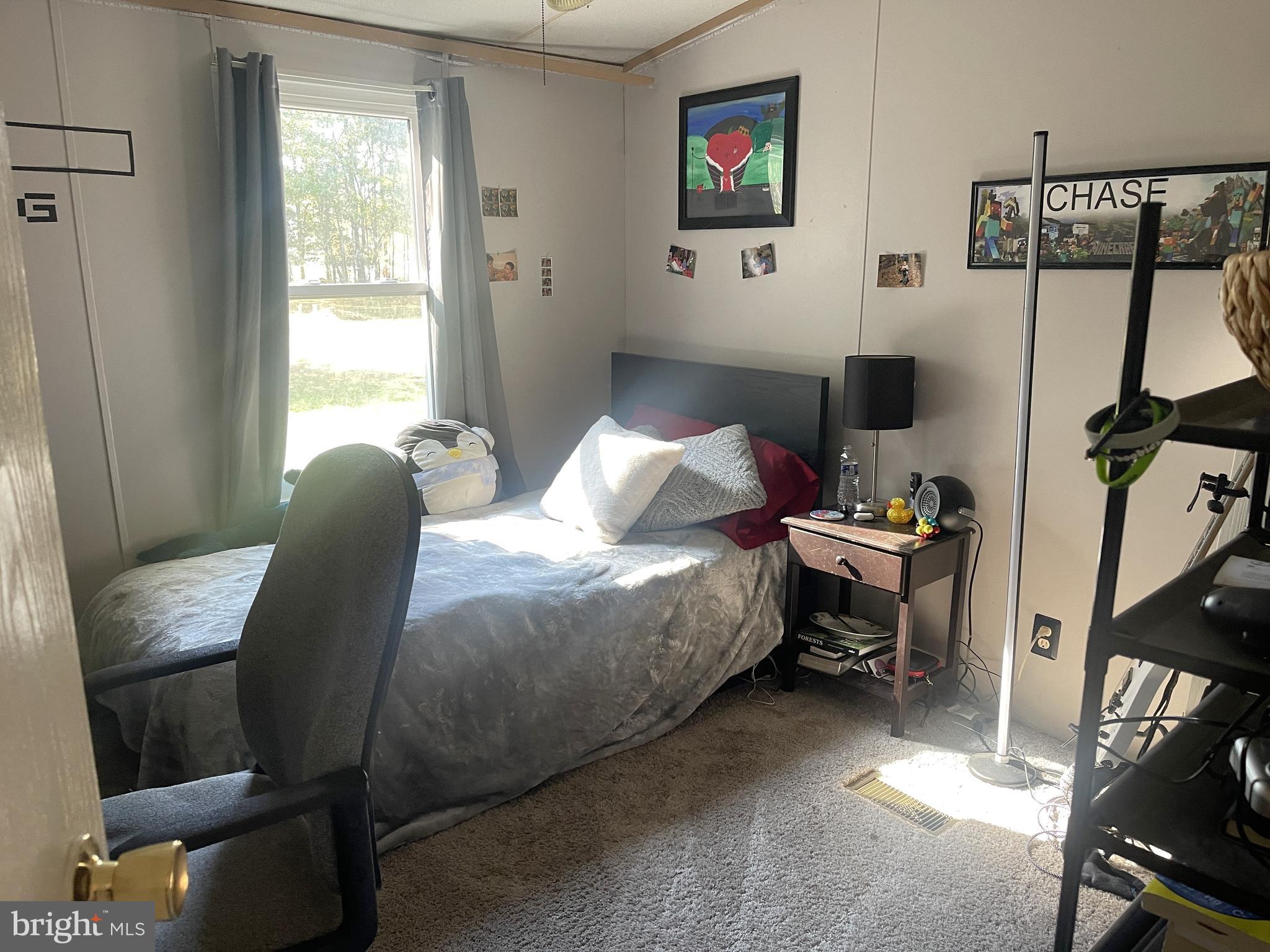 653 Blackbeard Pond Road Hague, VA 22469 - Photo 11 of 14 a bedroom with a bed and a window