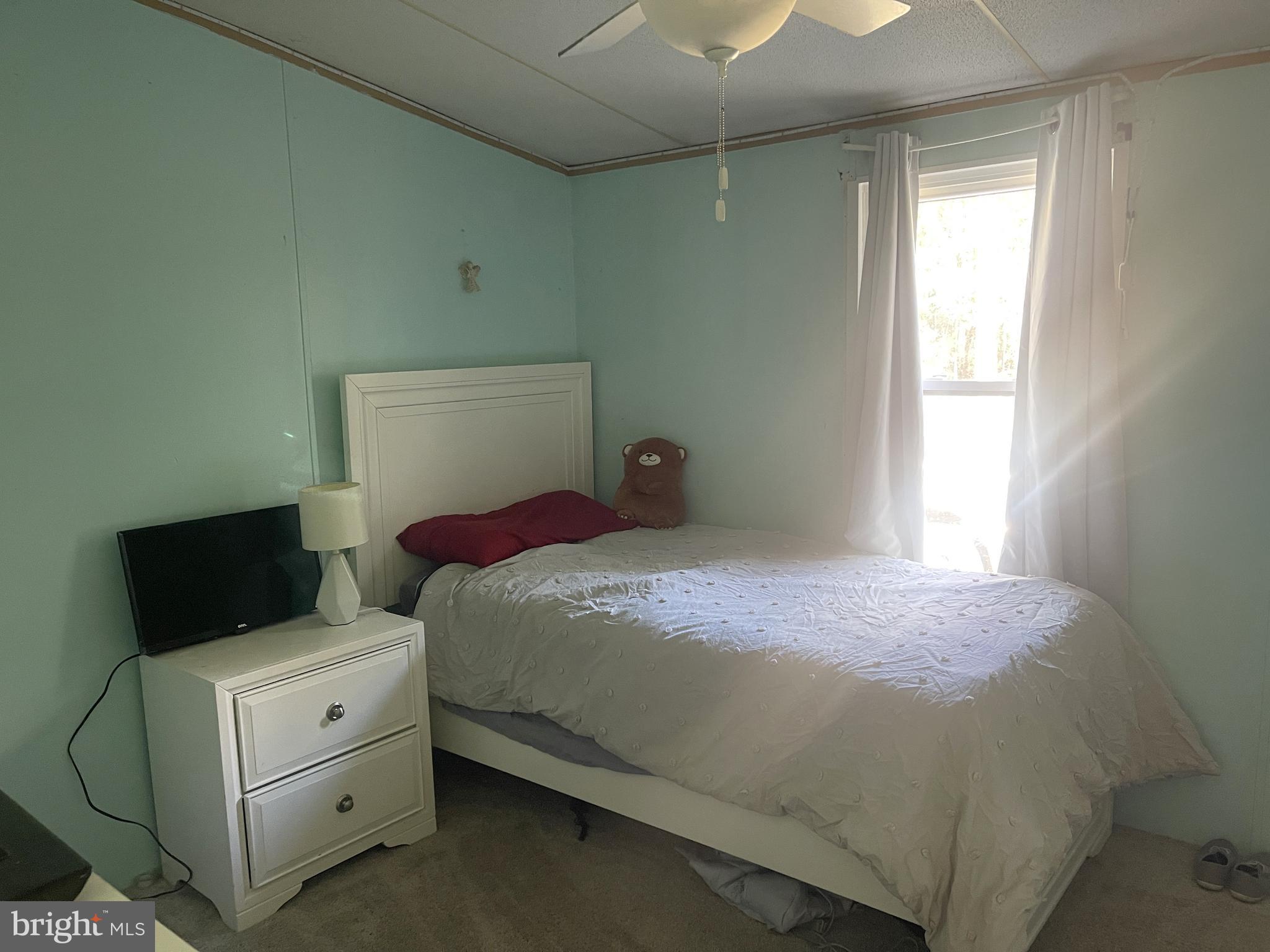 653 Blackbeard Pond Road Hague, VA 22469 - Photo 12 of 14 a bedroom with a bed and a window