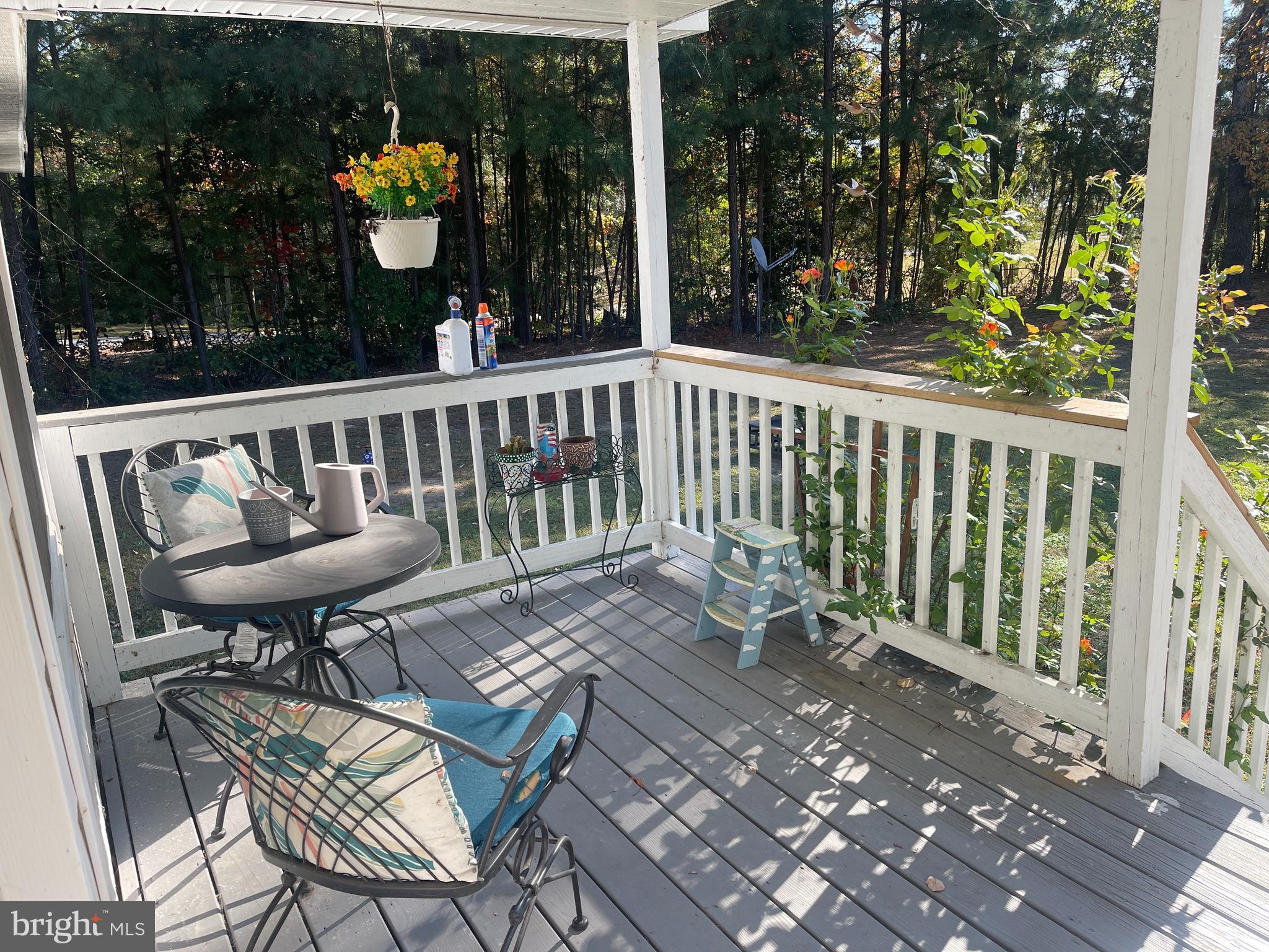 653 Blackbeard Pond Road Hague, VA 22469 - Photo 3 of 14 a view of a chairs and table in the balcony