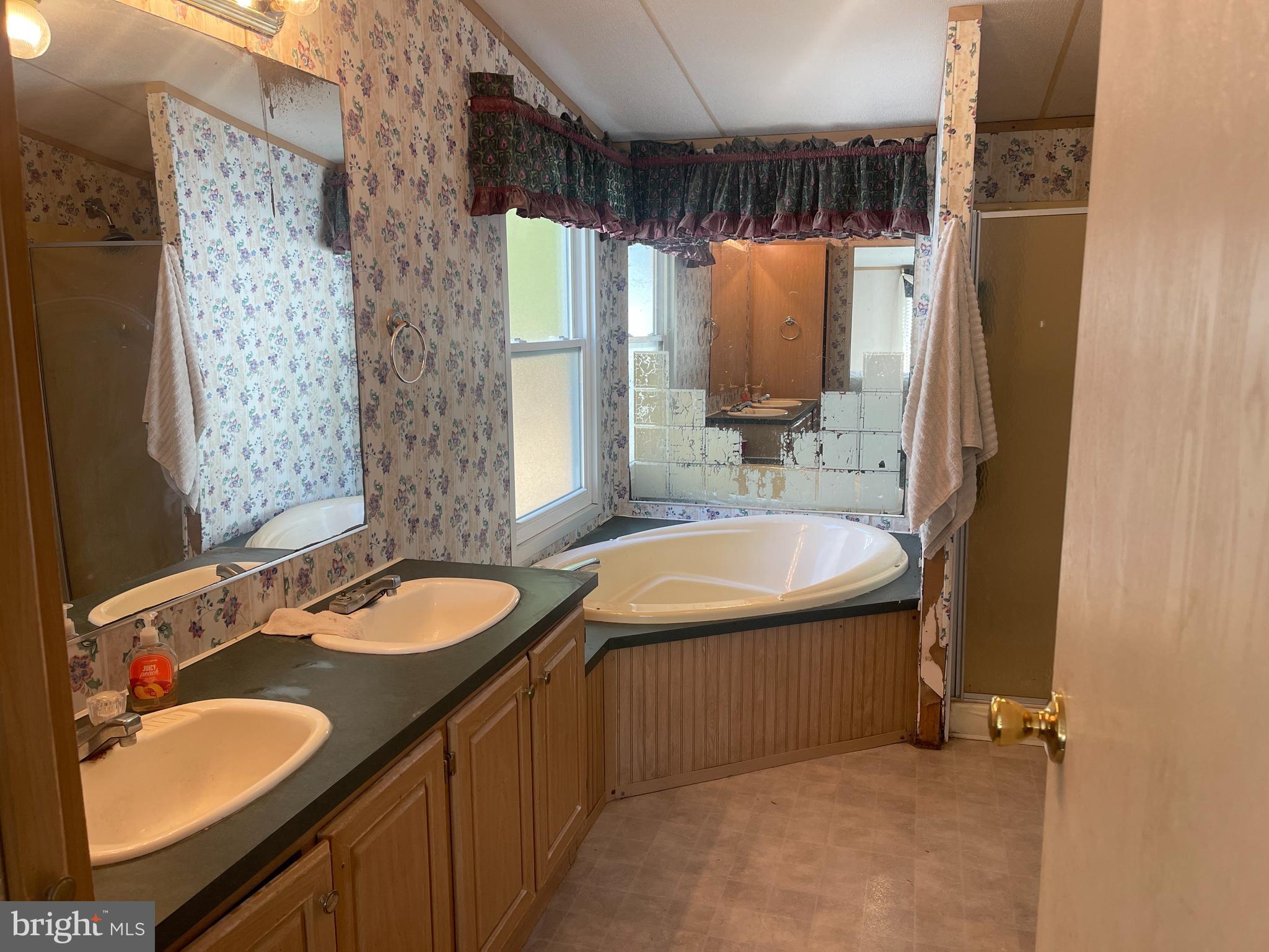 653 Blackbeard Pond Road Hague, VA 22469 - Photo 9 of 14 a bathroom with a sink and a mirror