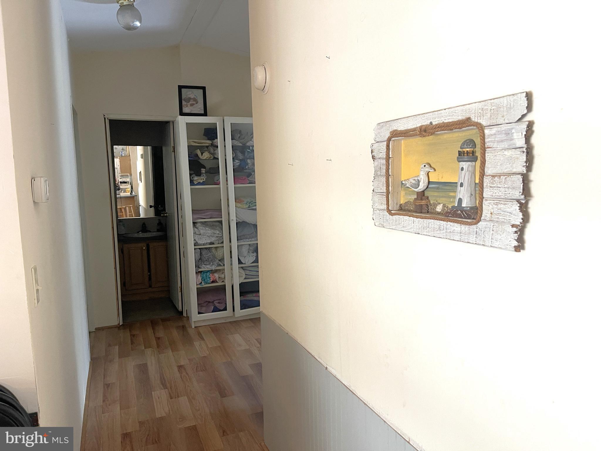 653 Blackbeard Pond Road Hague, VA 22469 - Photo 10 of 14 a view of a hallway with wooden floor and closet
