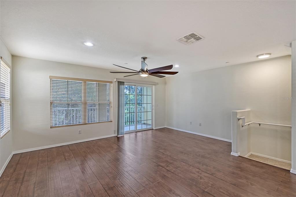 8922 White Sage Loop Lakewood Ranch, FL 34202 - Photo 11 of 65 a view of an empty room with a window and wooden floor